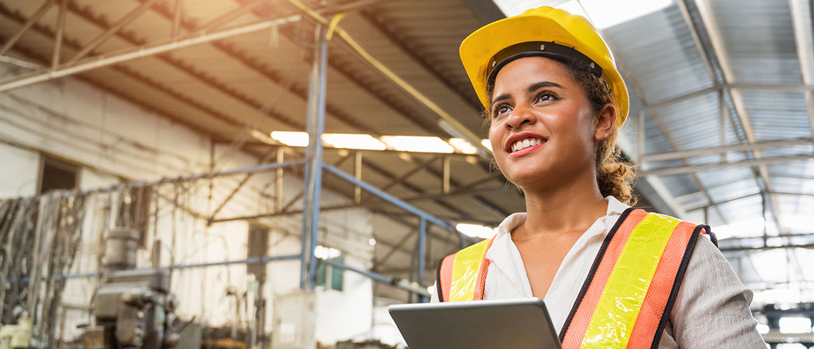 Industrial worker checking on equipment to make sure it functions properly and safely Industrial worker checking on equipment to make sure it functions properly and safely