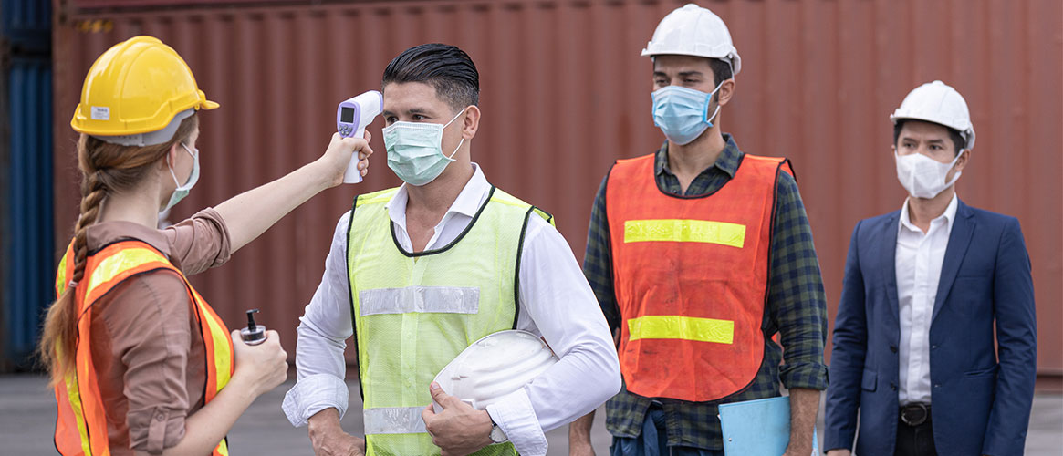 Supervisor conducting COVID-19 temperature screening of employees